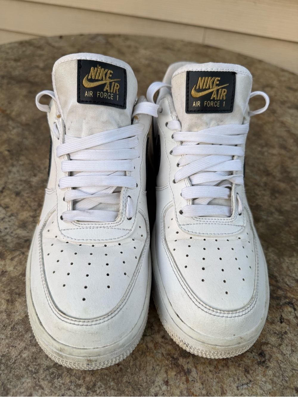 Nike White Sneakers with Gold Tongue Logo